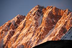 
The Shishapangma Southwest Face burns orange at sunset from Shishapangma Southwest Advanced Base Camp (5276m).
